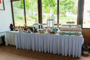 Sweet cakes at a wedding banquet. Catering, sweet festive buffet. Candy bar