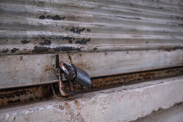 Closed shop shutter and padlock. Economic crises and bankruptcies.