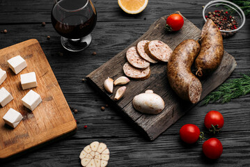 smoked homemade sausage on a wooden background and an old wooden hot smoked sausage