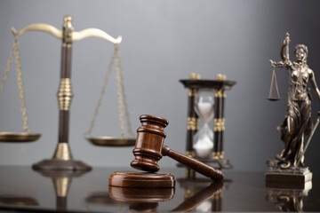 Law and justice concept. War crimes. Gavel, Themis sculpture and scale in lawyers office. Gray background.