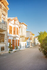 Fototapeta na wymiar Streetscape with old historical colorful houses on a summer day in the old town. Princes' Islands, Turkey
