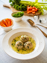 Boiled meatballs in dill sauce on white table
