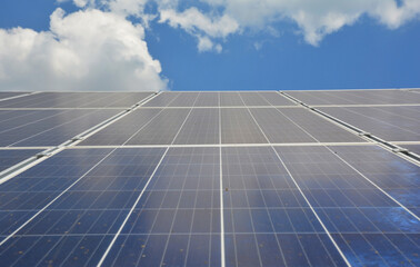 A close-up of solar panels against the sky. A bottom up view of photo voltaic cells, solar module as a concept of renewable, sustainable green energy, solar power.