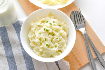 Mashed potatoes in a white bowl. Flat lay top view photo. Food from above concept.