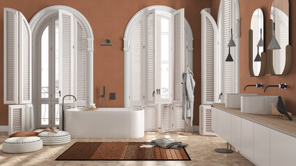 Modern bathroom in orange tones in classic apartment with arched window. Freestanding bathtub, washbasins, mirrors, carpet, rack with towels and bathrobe. Minimalist interior design