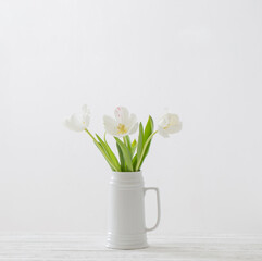 Naklejka na ściany i meble white tulips in jug on white background