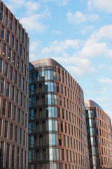 Fototapeta premium Modern real estate glass facade vertical background. Architecture details.