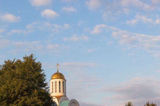 Golden church top evening cloudy sky background. - Powered by Adobe