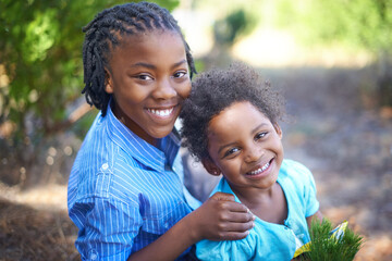 Hes an excellent big brother. Cute african american siblings spending time together in nature.