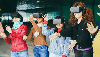 Young people wearing virtual glasses outdoor - Metaverse concept - Focus on girl¡s face with jeans...