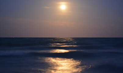 Fototapeta premium the moon illuminates the waves of the sea