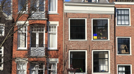 Amsterdam Spiegelgracht Canal House Facades Close Up with Ukrainian Flag Colors at the Window,...