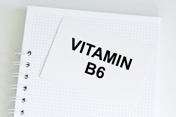 Blue card with text VITAMIN b6 on a table
