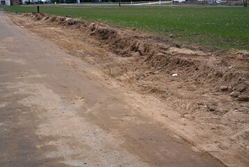 A land road and a farmland in the countryside 
