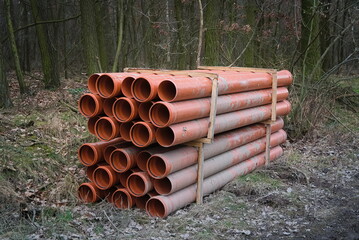 A stack of plastic water supply pipes  - 491987383