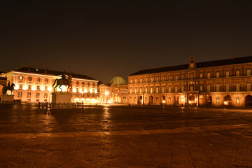 Fototapeta na wymiar Night view of Plebiscito square in the center of Naples, Italian city. Important buildings from different historical periods overlook the circular square.