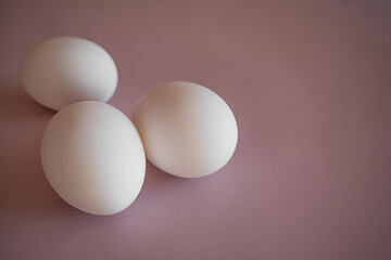 white eggs on a pink background, easter, close up,