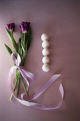 bunch of tulips with ribbon and easter white eggs, empty space