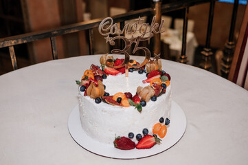 Beautiful wedding cake decorated with flowers, cake close up and blur background