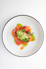 Salmon and avocado salad. Avocado puree. Healthy food. An isolated object.Photo on a white background for the menu.Vertical photo.Flat lay.Top view.Copy space.