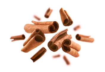 Cinnamon sticks levitate on a white background