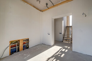 empty white room without repair and furniture with scaffolding with wooden stairs