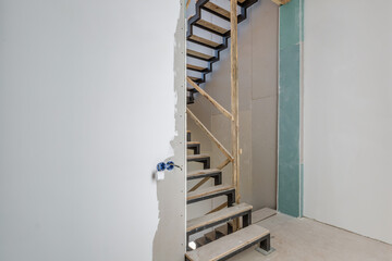 empty white room without repair and furniture with scaffolding with wooden stairs