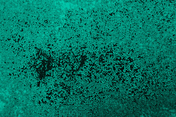 Fototapeta na wymiar Light green abstract rough background. Old dirty damaged painted wall. Close-up. Teal background with copy space for design.