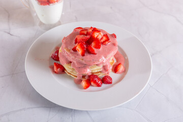 Strawberry pancakes on a white background.