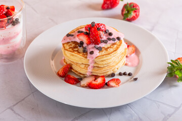 Strawberry pancakes on a white background.