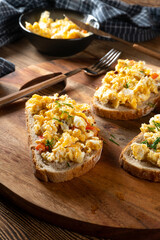 Scrambled eggs on a slice of bread.