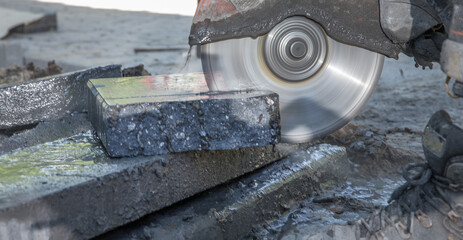 Concrete saw. Cutting concrete tiles with electric sawing machine. Netherlands.