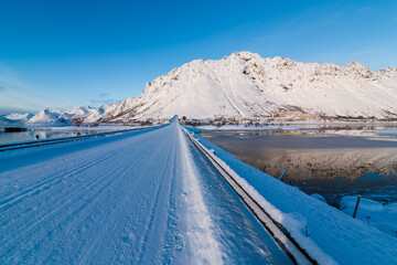 Lofoten, Norway - beautiful coast, bridge, viaduct, road, snow-covered rocks