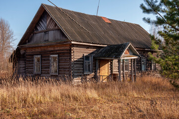 Early spring sky over  village with small wood log local house and low fence. Travelling on the suburb roads. People living