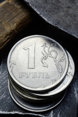 Russian coin with a face value of 1 ruble. and an old working tool. close-up. translation of the text on the coin 