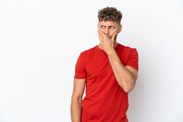 Young caucasian handsome man isolated on white background having doubts and with confuse face expression