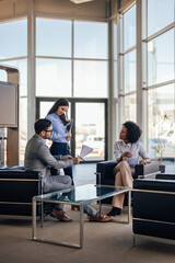 Relaxed modern office workers, reading a document together.