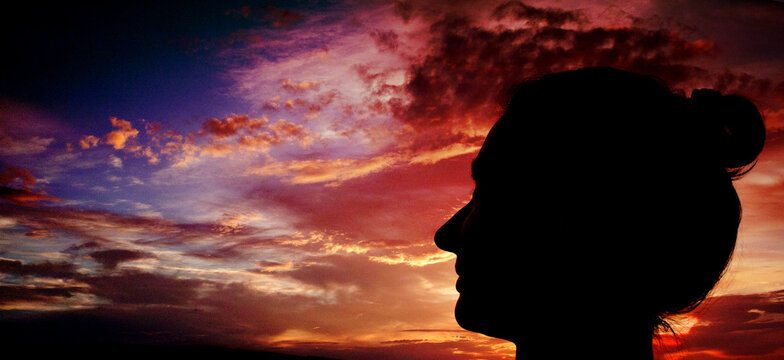 woman head silhouette at sunset mindfulness and meditation concept