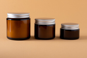 Candle in a jar with a lid mock-up of different sizes. A set of different aroma candles in brown...