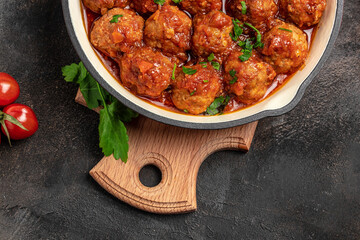 Traditional spicy meatballs in sweet and sour tomato sauce. Restaurant menu, dieting, cookbook recipe top view