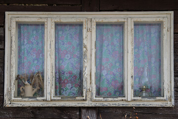 Sunja, Croatia, April 20,2021 : Rustic style aged window at rural home wall.