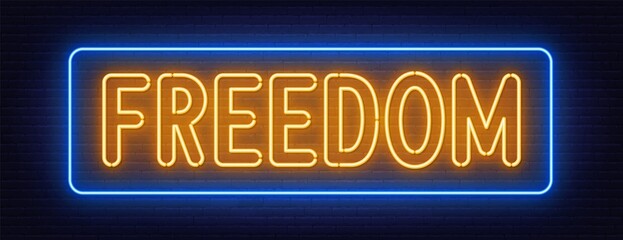 Freedom neon sign on brick wall background. © TanyaFox