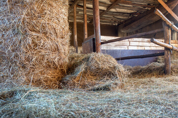 an old horse stable with hay, a barn. Old farm, ranch