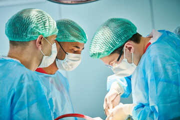 Emergency surgery. Surgeons during surgical intervention in clinic