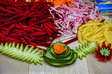 Carving flowers from vegetables .