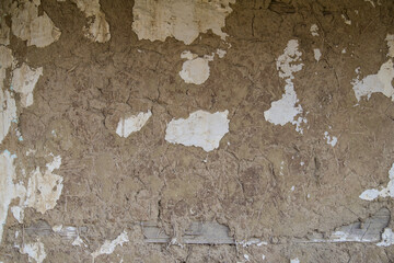 Sunja, Croatia, April 20,2021 : Facade of mud and straw on old wooden house.