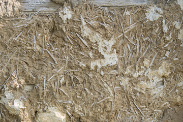 Sunja, Croatia, April 20,2021 : Facade of mud and straw on old wooden house.