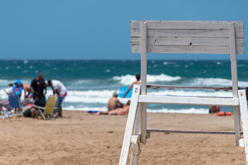 Selective focus of a chair with the beach out of focus in the background.