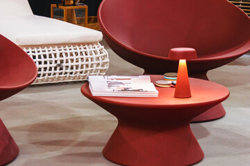 Red round plastic table with lamp.