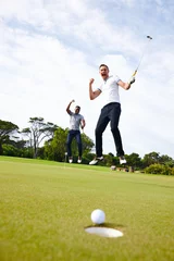 Fototapete Rund How could golf ever be boring. Low angle shot of a golf ball approaching the hole while two golfers look on. © Daniel Laflor/peopleimages.com